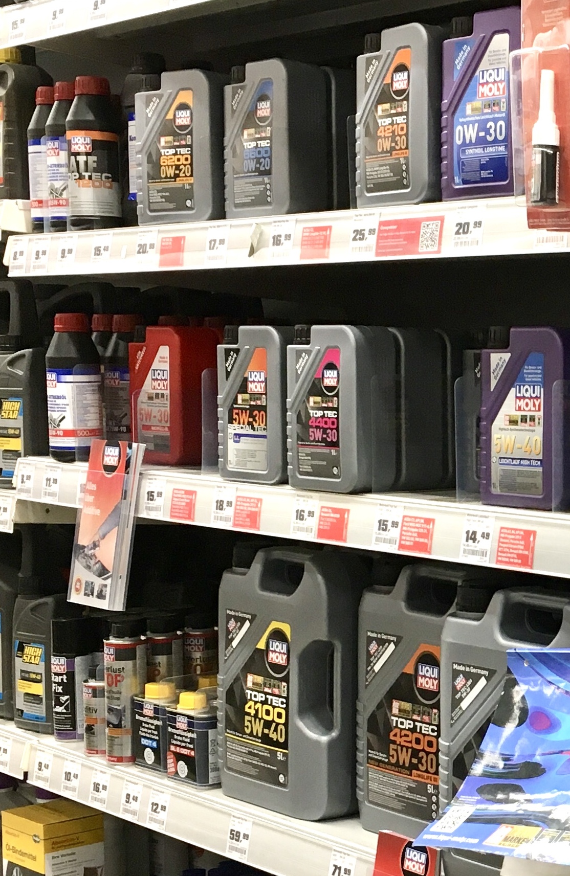 Motor oil bottles on a hardware store shelf
